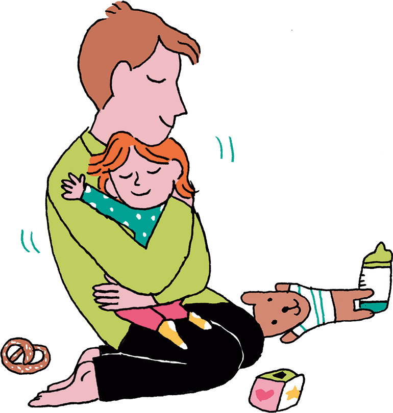 Un papa enlace sa petite fille dans ses bras.